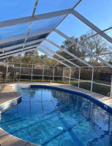 una gran piscina con dosel blanco en Guest House In Cantonment, en Jacksonville