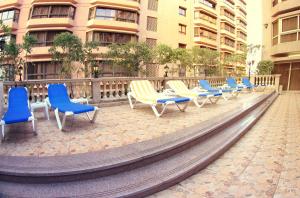 a row of chairs sitting in front of a building at Pyramisa Suites Hotel Cairo in Cairo