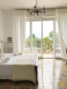 a bedroom with a large bed and a large window at Casa Dolci Rodolfo large bright apartment 4km to Seaside in Montemarciano