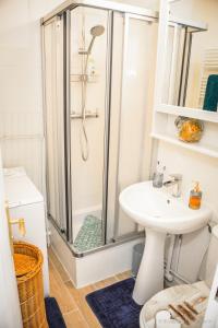 a bathroom with a shower and a sink at STUDIO COSY in Cabourg