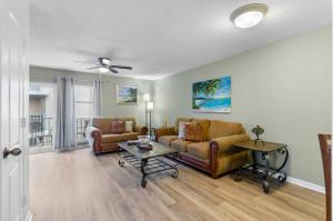 a living room with a couch and a table at #250G Madeira Beach Yacht Club in St Pete Beach