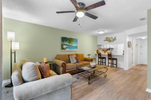 a living room with a couch and a ceiling fan at #250G Madeira Beach Yacht Club in St. Pete Beach