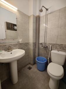 a bathroom with a toilet and a sink and a shower at 2 Bedrooms Presidential Apartment-HS Apartment in Islamabad