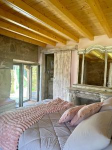 a bedroom with a large bed and a mirror at El nido del cuco in Padrón +29 photos