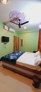 a bedroom with a bed with a ceiling at Shiv Niketan Guest House 200mtr from Shri Ram mandir in Ayodhya