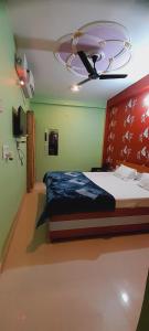 a bedroom with a bed and a ceiling at Shiv Niketan Guest House 200mtr from Shri Ram mandir in Ayodhya