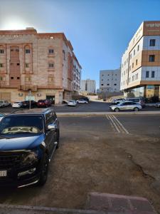 a black car parked in a parking lot at شقة طيبه المدينة 5 in Al Madinah