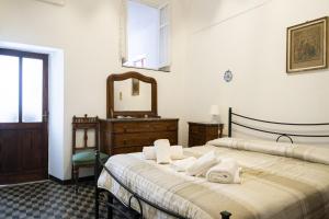 twee bedden in een kamer met een spiegel en een dressoir bij Arcani Family Apartment by Wonderful Italy in Finale Ligure