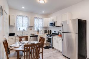 a kitchen with a table and a refrigerator at Charming Retreat Near XU in Cincinnati