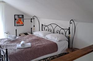 a bedroom with a large bed with a metal frame at Emas House in Gornja Stubica