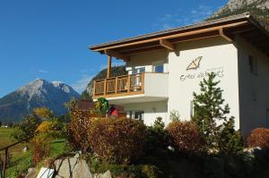 a building with a balcony on the side of it at Appartements Erhol dich gut in Leutasch +11 photos