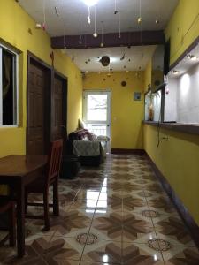a dining room with a table and yellow walls at Hostal Candelaria in San Juan La Laguna