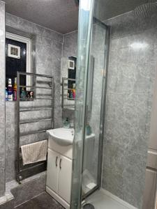 a bathroom with a shower and a sink at Room 2 • Double Bed in Primrose Hill in London