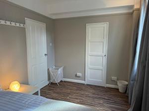 a bedroom with a bed and a white door at Room 2 • Double Bed in Primrose Hill in London