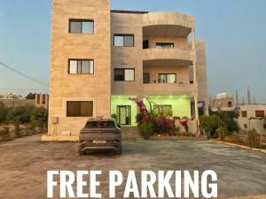 a sign that says free parking in front of a building at Jerash Heart in Jerash