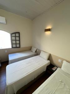 Ένα ή περισσότερα κρεβάτια σε δωμάτιο στο Hotel Casarão