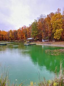 a large lake with a gazebo in the middle at Letchworth Farm Guesthouses in Nunda