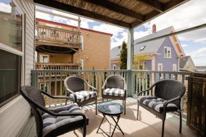 a balcony with chairs and a table on a balcony at Bright Spacious Apartment - 2 BR 2 BA in Portland