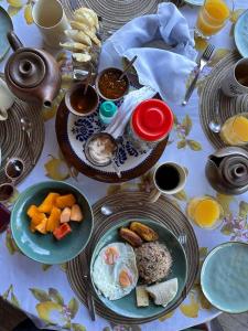 una mesa con platos de desayuno. en Casa Monte Armadillo, en Poás