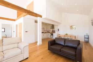 a living room with a couch and a table at Trippet Cottage in Saint Breward