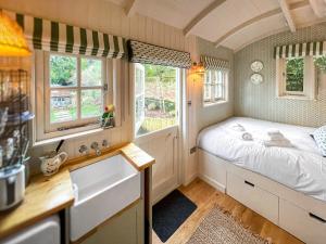 a small bedroom with a bed and a sink at The Granary in Steyning
