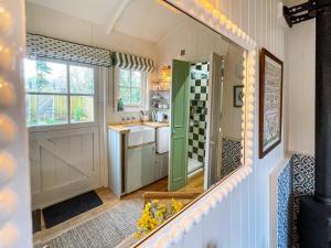 a kitchen with a green door and a sink at The Granary in Steyning