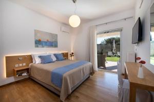 a bedroom with a bed and a sliding glass door at Meraki Cretan Hospitality in Maleme