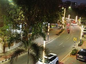 a city street with cars and motorcycles at night at J Beach Stay Rooms in Visakhapatnam
