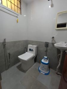 a bathroom with a toilet and a sink at J Beach Stay Rooms in Visakhapatnam