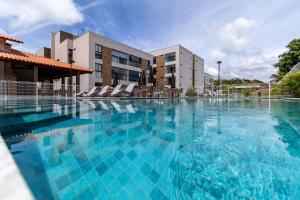 a large swimming pool in front of a building at Apto Póximo a Praia de Barra de São Miguel - Destino BSM 106 A in Barra de São Miguel