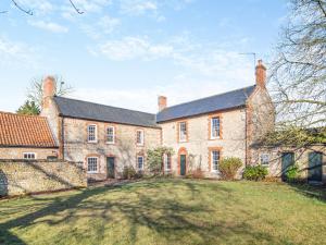 a large brick house with a large yard at Red House in Methwold