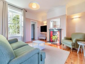 a living room with a couch and a fireplace at Red House in Methwold