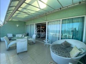 a room with a balcony with a table and chairs at cobertura duplex in Rio de Janeiro