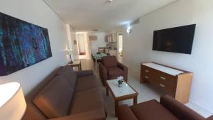- un salon avec un canapé et une télévision dans l'établissement PH1401 Hotel Margarita Real, à Porlamar