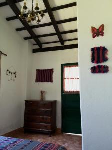a bedroom with a green door and butterflies on the wall at Finca San Francisco y San Javier (ex Finca los tres changos) in Salta