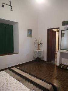 a living room with a green door and a table at Finca San Francisco y San Javier (ex Finca los tres changos) in Salta