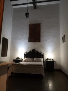 a bedroom with a bed and two night stands at Finca San Francisco y San Javier (ex Finca los tres changos) in Salta