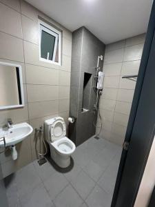 a bathroom with a toilet and a sink at Mont kiara Warmly Home A-29-06 in Kuala Lumpur