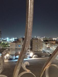 a view of a parking lot at night at Al Ghazali Suites, اجنحة الغزالي للشقق المفروشه in Medina