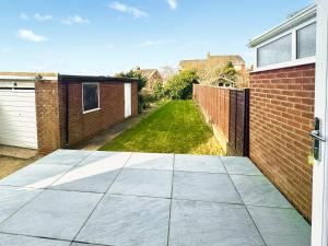 a driveway of a house with a brick wall at Larch Cottage in Barrow in Furness