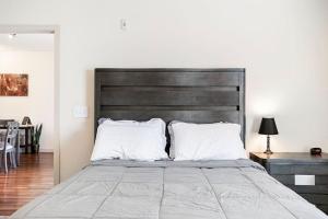 a bedroom with a large bed with a wooden headboard at Rustic Paradise In Downtown OKC. in Oklahoma City