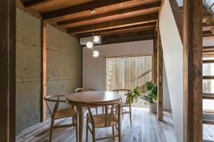 a dining room with a wooden table and chairs at 6ishiki in Kameoka