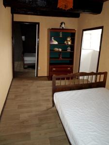 a bedroom with a bed and a dresser at Maison de 3 chambres avec jardin amenage a Sibiril a 3 km de la plage in Sibiril