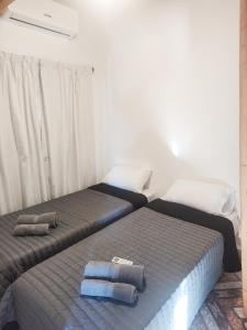 a bedroom with two beds with towels on them at Apartamentos Mara - 100m de Termas in Federación
