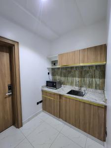 a kitchen with a sink and a counter at Samuel Court in Abuja
