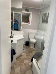 a man taking a picture of a bathroom at BBs B&B in Lower Hutt