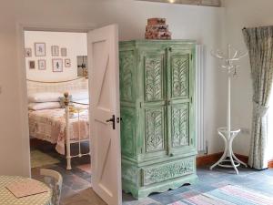 a green cabinet in a room with a bed at Pippin - Uk37379 in Pilton