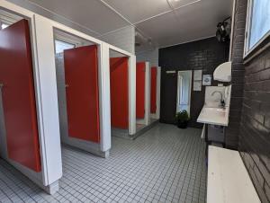 a bathroom with red stalls and a sink in it at The Peaks 2 in Dadswells Bridge +14 photos