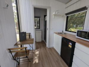 a kitchen in a tiny house with a counter and a sink at Tiny House 15 at Grampians Edge in Dadswells Bridge