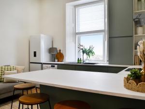 a kitchen with a large white island in a room at Main Street Flat A - Uk46448 in Ayr